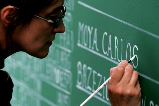 Artwork can be seen all around the Stade Roland Garros complex. Here a woman paints stadium signage on day five of the 2007 French Open.