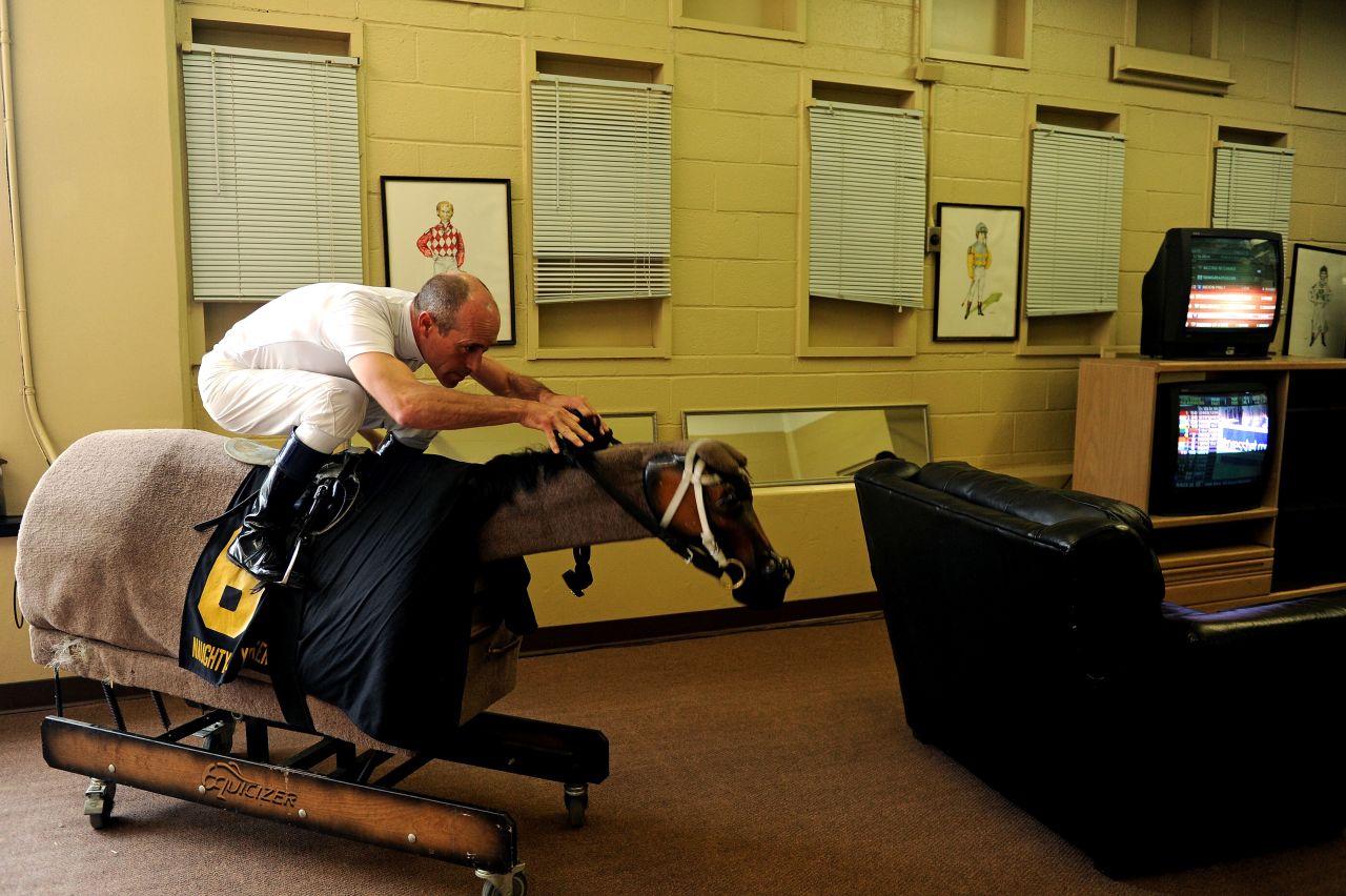 He works tirelessly to get himself in shape -- here he tackles a mechanical horse to prepare himself for racing.