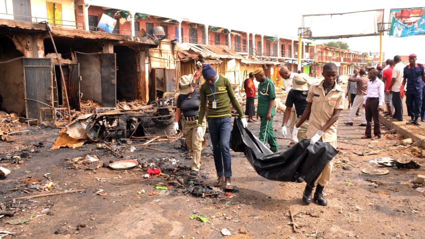 Rescuers carry a body recovered from a burnt shop at the scene of twin bomb blasts at terminus market in the central city of Jos on May 21, 2014. Twin car bombings in central Nigeria killed at least 118 people and brought entire buildings down Tuesday, in the latest affront to the government's internationally-backed security crackdown. Nigerian President Goodluck Jonathan swiftly condemned the attack in the central city of Jos, calling it a "tragic assault on human freedom" and condemning the perpetrators as "cruel and evil". AFP PHOTO/ STRSTR/AFP/Getty Images