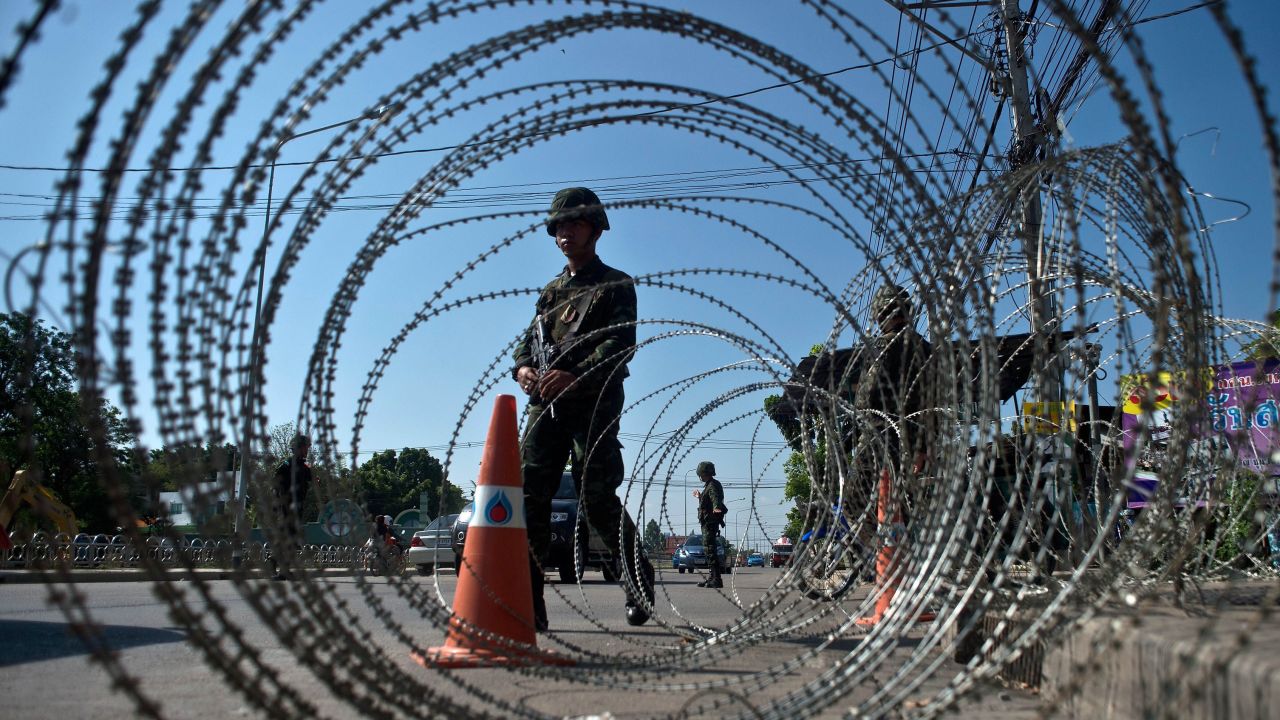 Thai soldiers stand guard at a checkpoint outside of Bangkok on May 22.