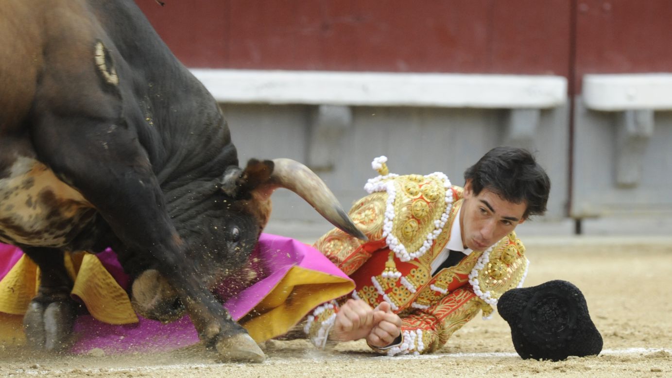 Jimenez eyes the horn of a bull as he is gored on May 20.