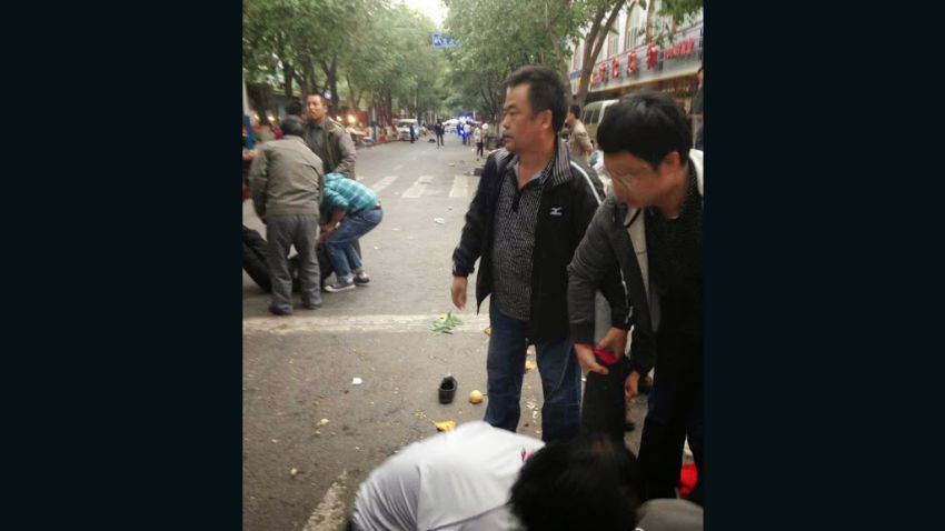 Image posted on Weibo purportedly shows victims being helped following explosions at a market in Urumqi Thursday.