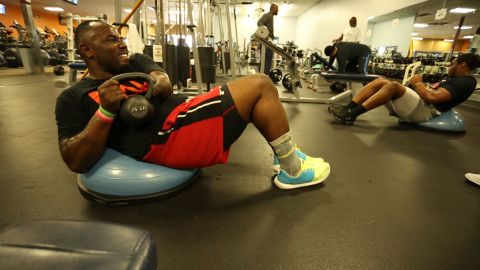 Harmon works out with a kettlebell.