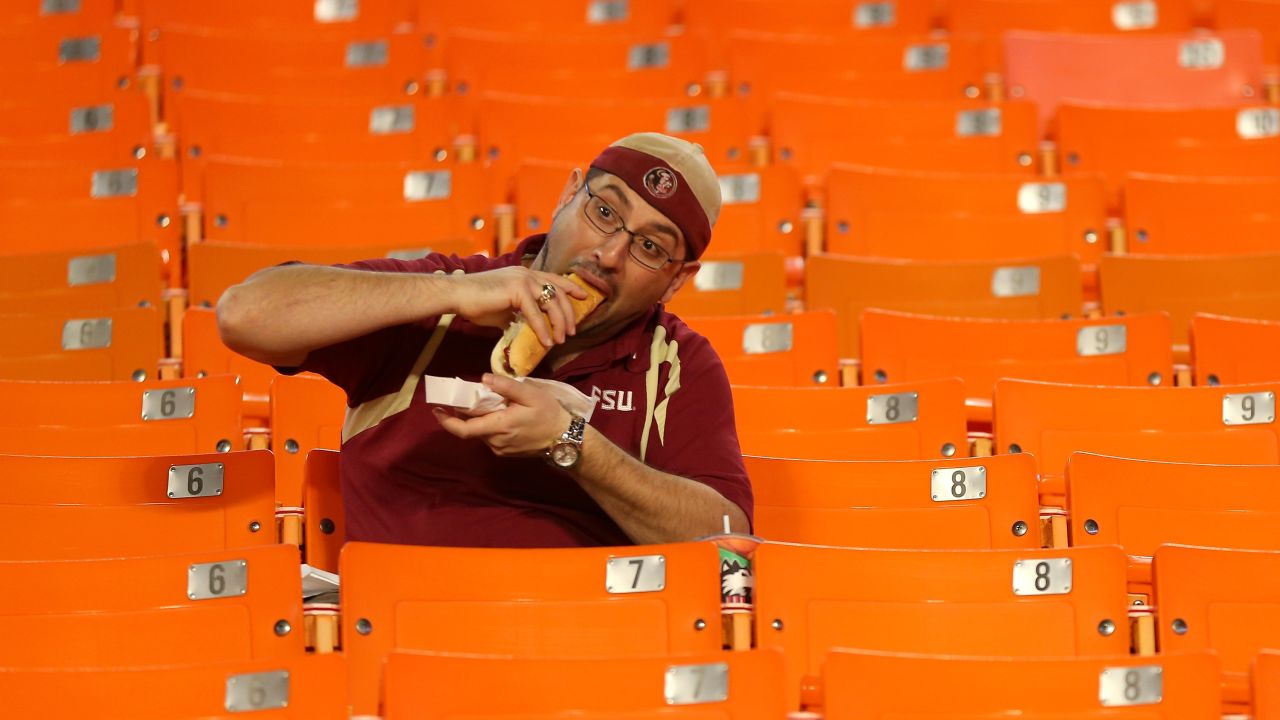 A Florida State Seminoles fan eats a hot dog prior to the 2013 Orange Bowl at Sun Life Stadium in Miami Gardens, Florida.