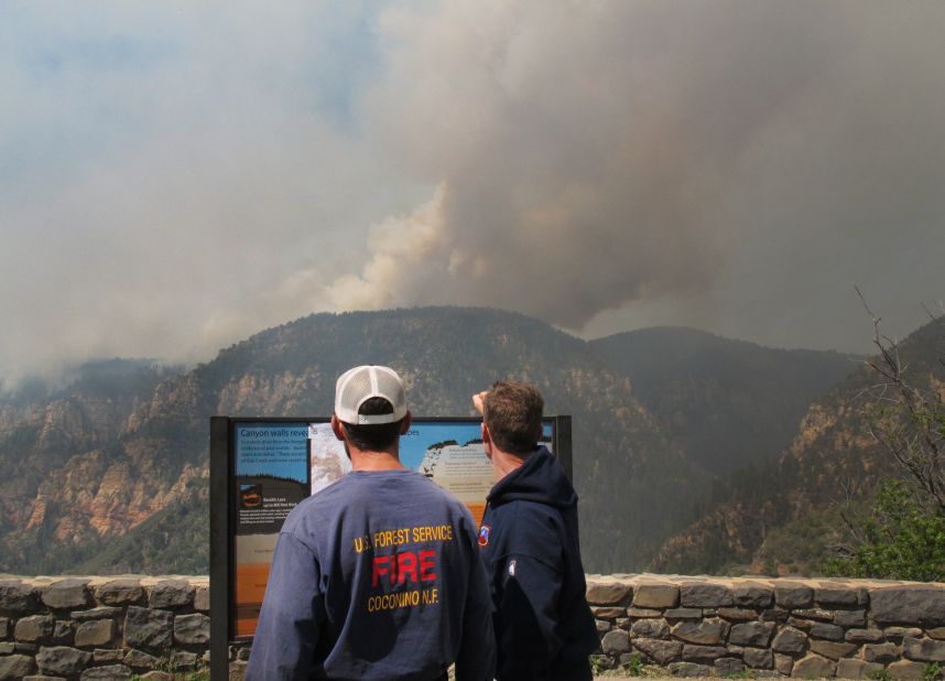 Coconino National Forest Battalion Chief Preston Mercer, left, and fire information officer Bill Morse survey the fire burning in Oak Creek Canyon, Arizona, on Wednesday, May 21.