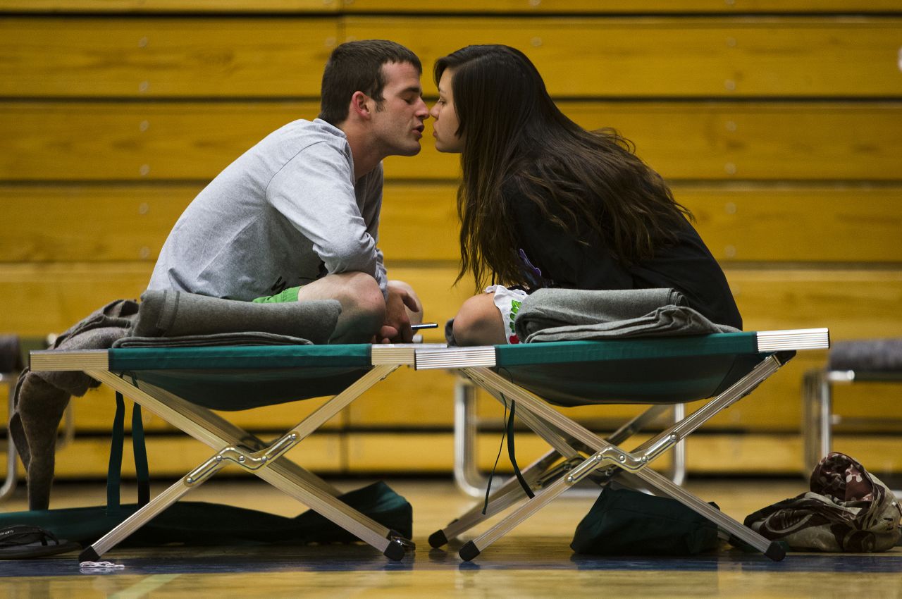 Nathan Westerfield kisses his wife, Mickella, at the Red Cross shelter set up at Sinagua Middle School in Flagstaff on Tuesday, May 20. The couple from Phoenix got married days earlier and were celebrating their honeymoon by camping out in Oak Creek Canyon.