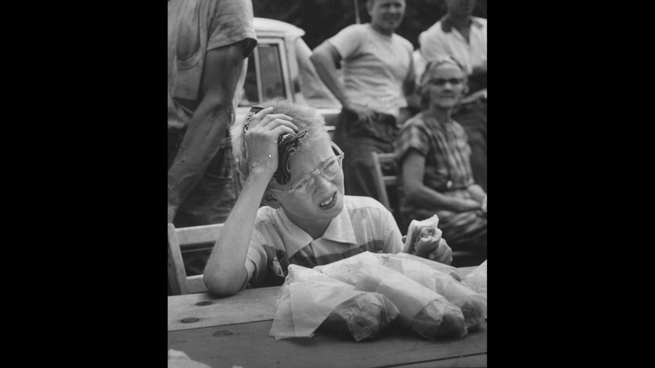 David Dittman winces as he competes in a hot dog eating contest in Danville, Illinois, in 1957.