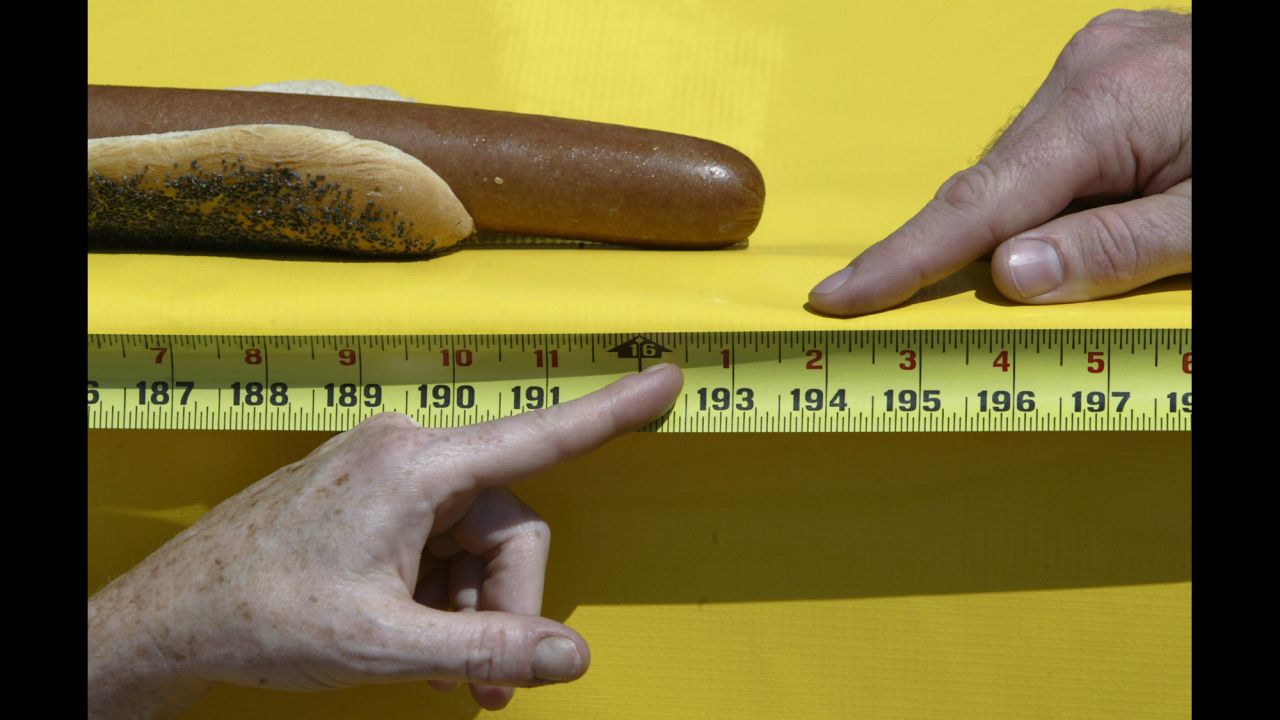 Judges in Chicago measure the length of the world's longest hot dog in 2003. At 16 feet and 1 inch, it bested the previous record of 15 feet, 3 inches.