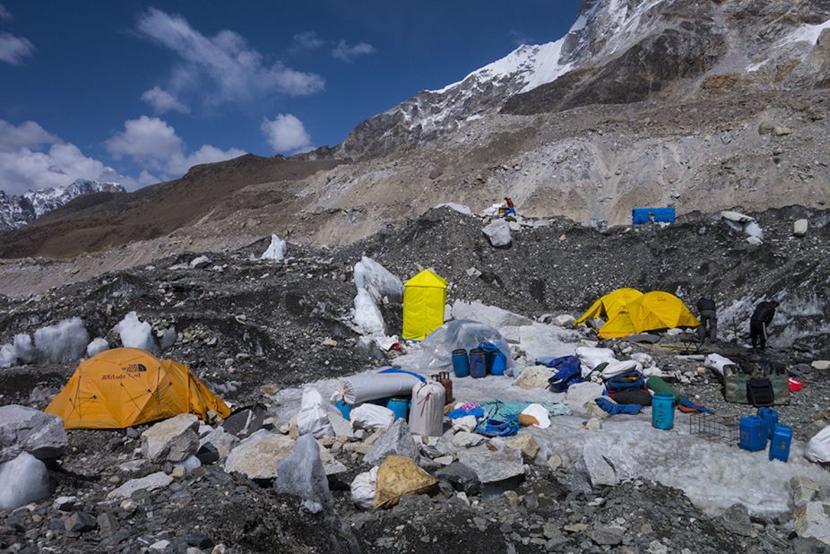 The camps of different expeditions being dismantled. Base Camp is usually a vibrant village. People play golf on the ice, hike along the icefall river, make new friendships, play cards during the day, and attend parties at night. 