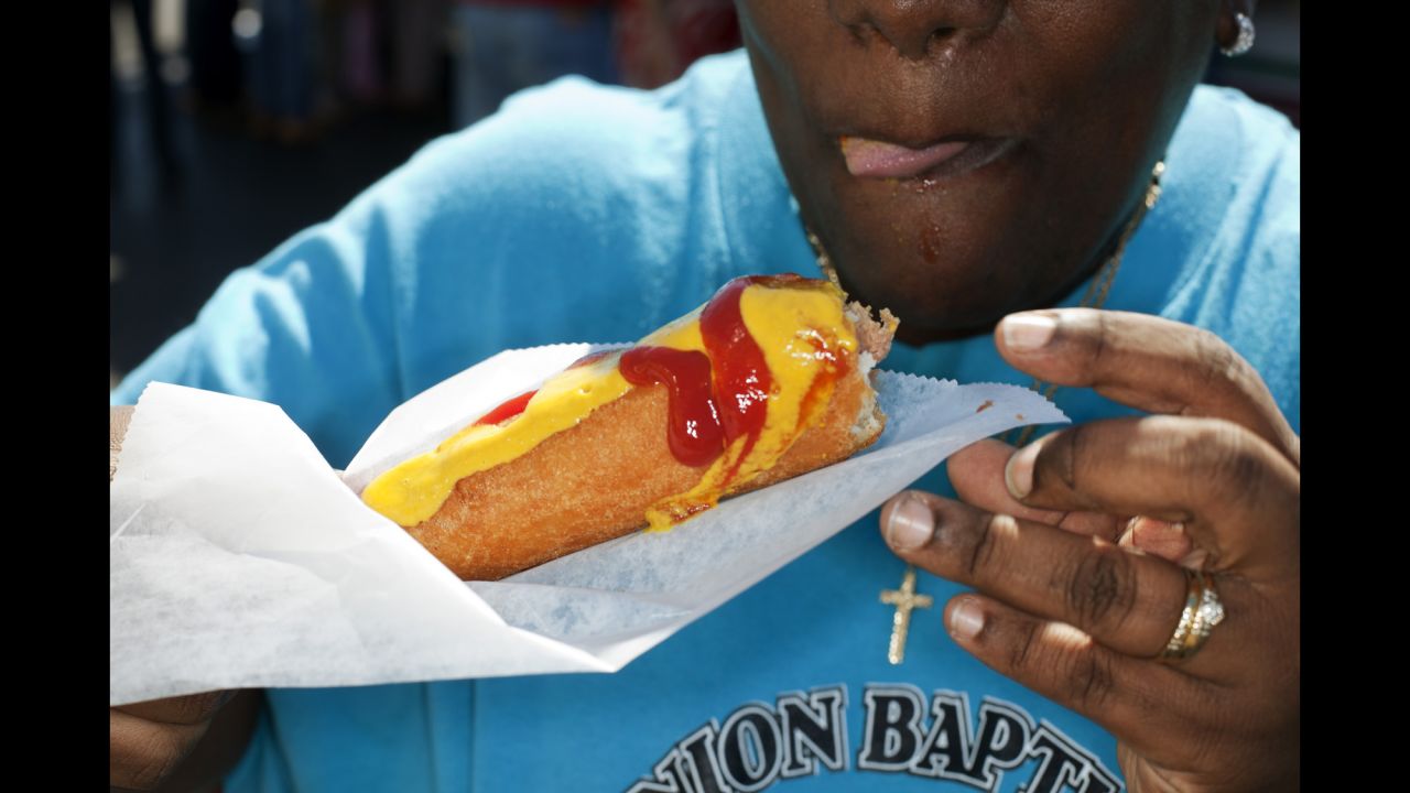 A Georgia State Fair attendee eats a corn dog in Atlanta in 2010.