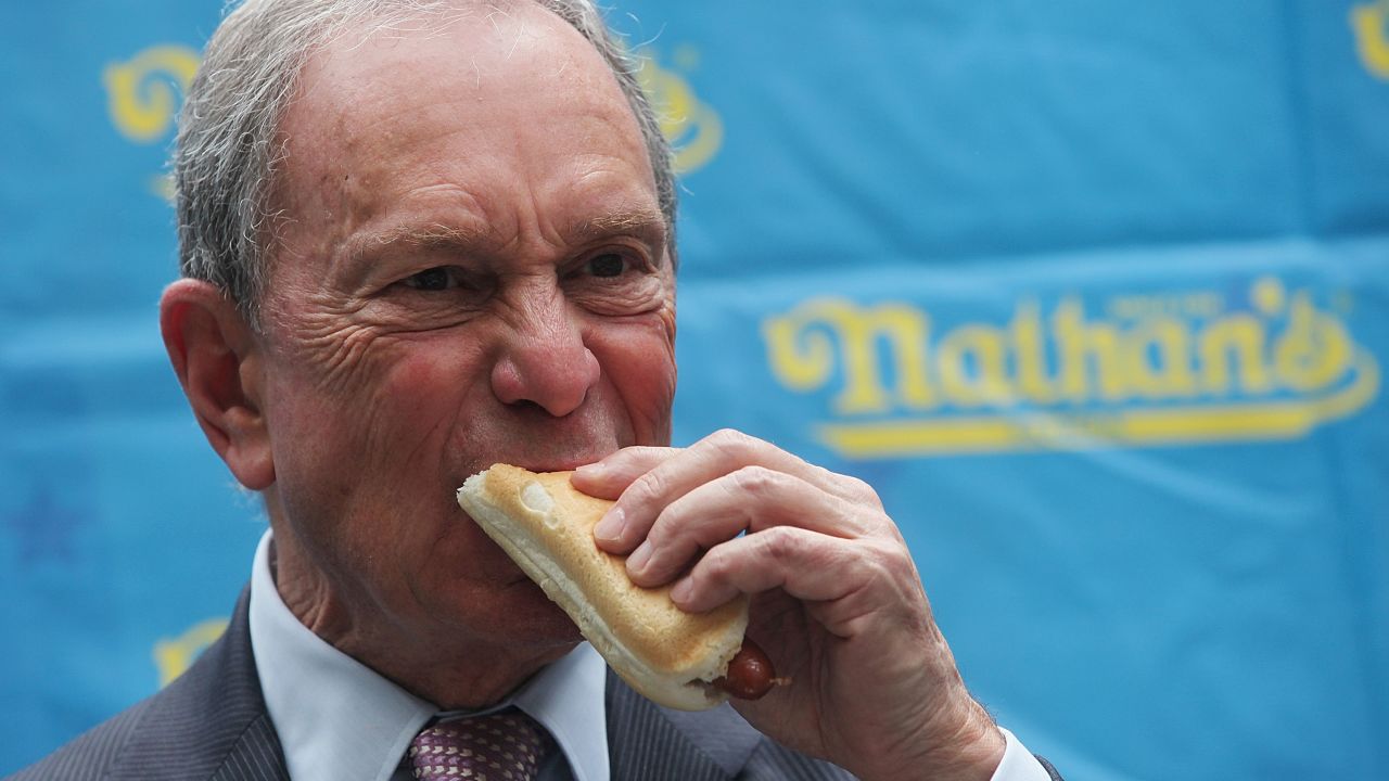 Then-New York Mayor Michael Bloomberg eats a hot dog at the weigh-in ceremony for the Nathan's July Fourth contest in 2013.