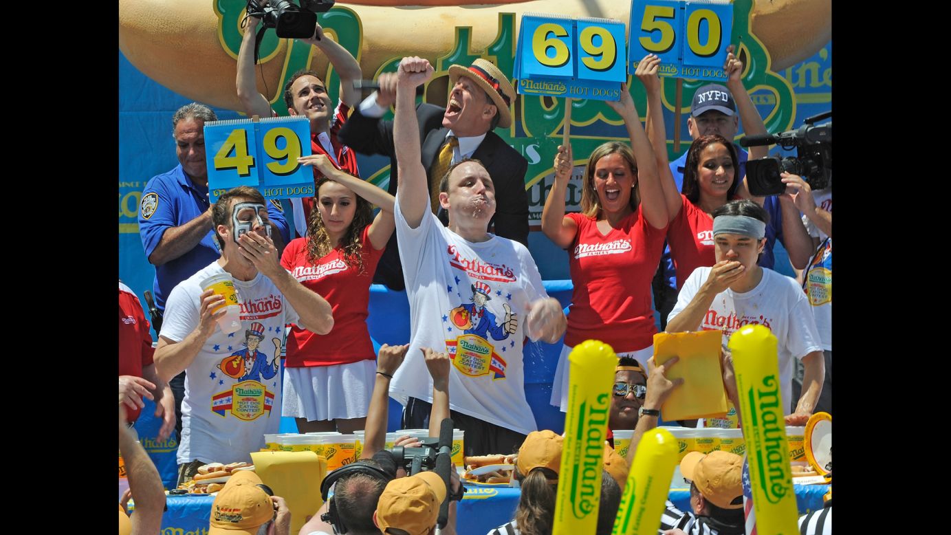 From left, Tim Janus, Joey Chestnut and Matt Stonie compete in the Nathan's hot dog eating contest in 2013.