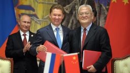 Russia's President Vladimir Putin (L) applauds during an agreement signing ceremony in Shanghai on May 21, 2014, with Gazprom CEO Alexei Miller (C) and Chinese state energy giant CNPC Chairman Zhou Jiping (R) attending the ceremony. China and Russia signed today a monumental, multi-decade gas supply contract in Shanghai, CNPC said, with reports saying it could be worth as much as $400 billion. AFP PHOTO / RIA-NOVOSTI / POOL ALEXEY DRUZHININALEXEY DRUZHININ/AFP/Getty Images