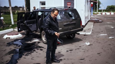 A man looks at a bullet shell next to a destroyed car after a gunfight between pro-Russian militiamen and Ukrainian forces in Karlivka, Ukraine, on Friday, May 23. Much of Ukraine's unrest has been centered in the Donetsk and Luhansk regions, where separatists have claimed independence from the government in Kiev.