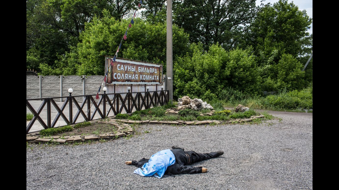 The body of a pro-Ukrainian militia fighter lies along a road in Karlivka on May 23.