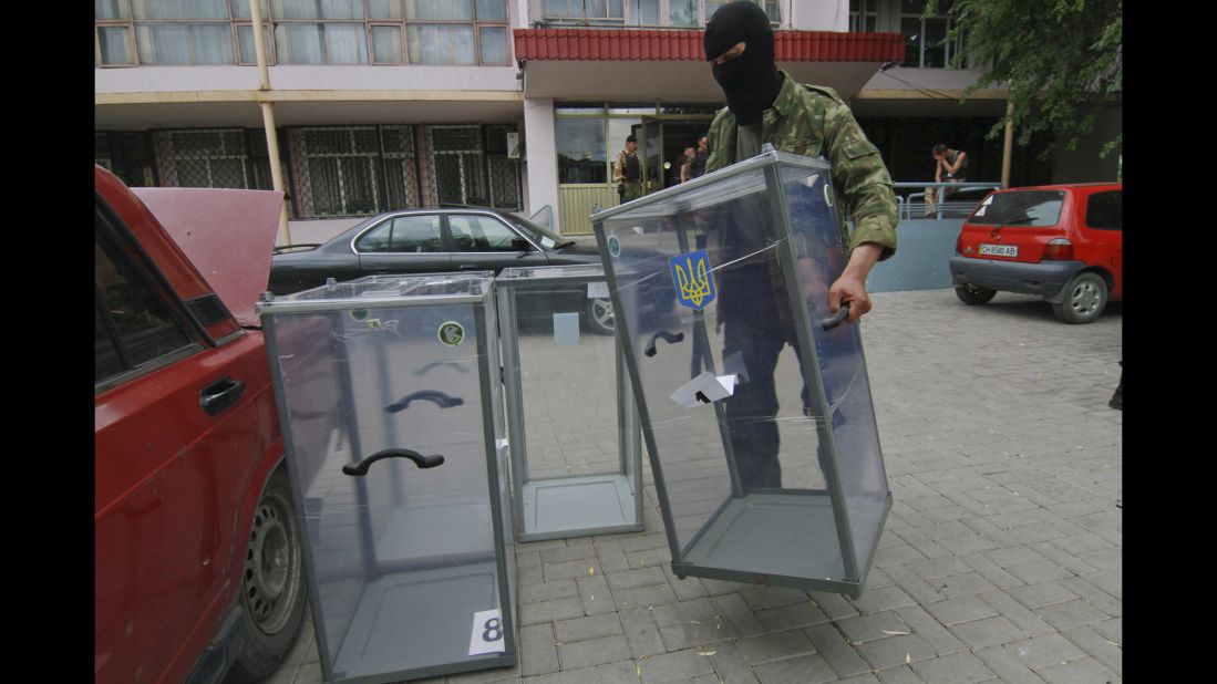 A pro-Russian activist carries a ballot box away from a polling station in Donetsk, Ukraine, as he prepares to smash it on May 23.