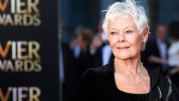 English actress Judi Dench poses for pictures on the red carpet upon arrival to attend the Lawrence Olivier Awards for theatre at the Royal Opera House in central London on April 13, 2014. AFP PHOTO/ANDREW COWIE        (Photo credit should read ANDREW COWIE/AFP/Getty Images)