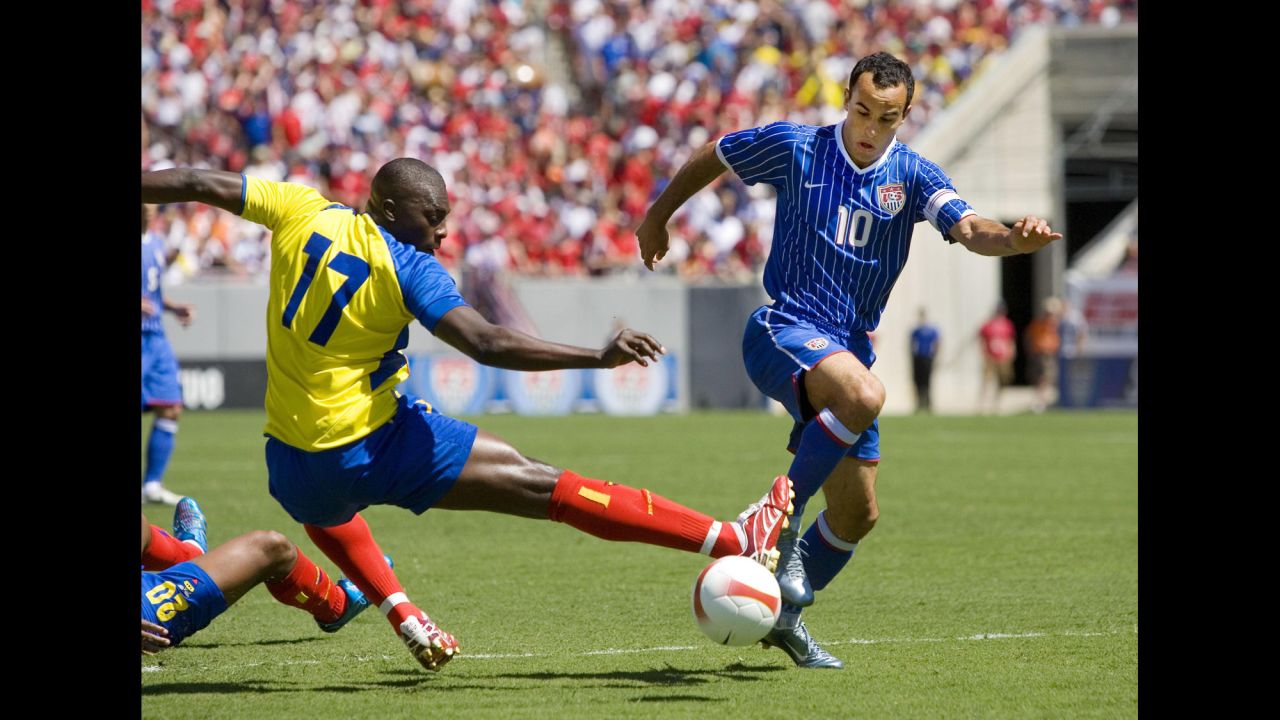 Donovan slides the ball around the outreached leg of Ecuador's Giovanny Espinoza in a 2007 international friendly match in Tampa, Florida. It was one of his three goals in the 3-1 win.