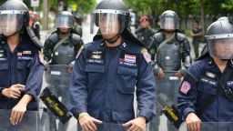 Thai police and army soldiers stand guard outside a military compound before former Prime Minister Yingluck Shinawatra arrives to report to Thailand's ruling military on May 23, 2014 in Bangkok, Thailand.T