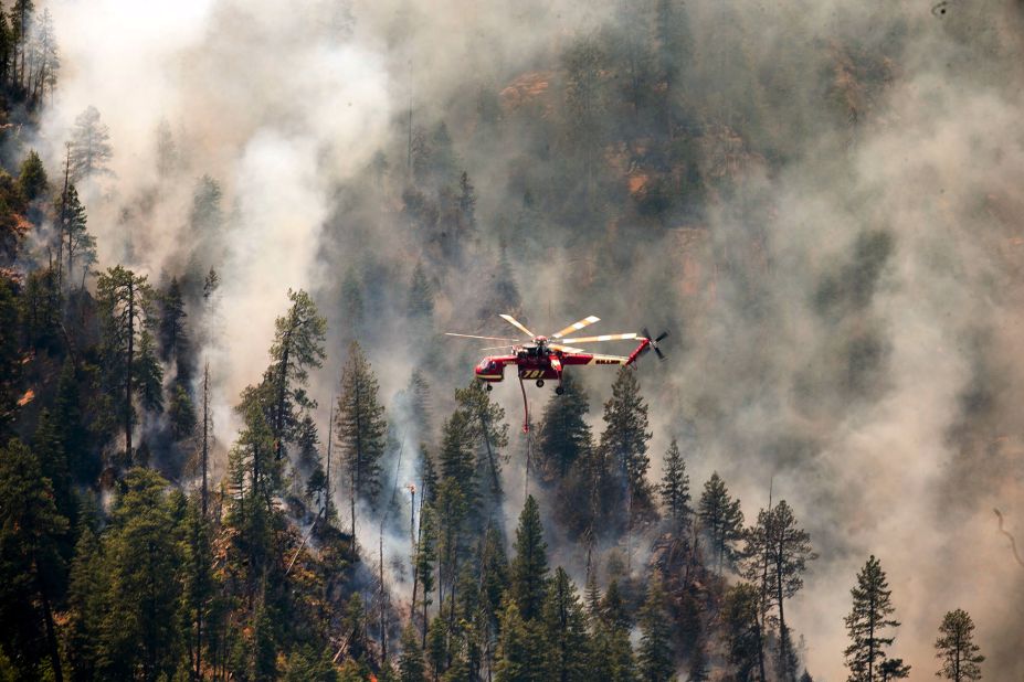 A helicopter helps battle the Slide Fire over Sterling Canyon in Sedona, Arizona, on Thursday, May 22. Hundreds of firefighters are battling high winds and steep terrain to contain the blaze.
