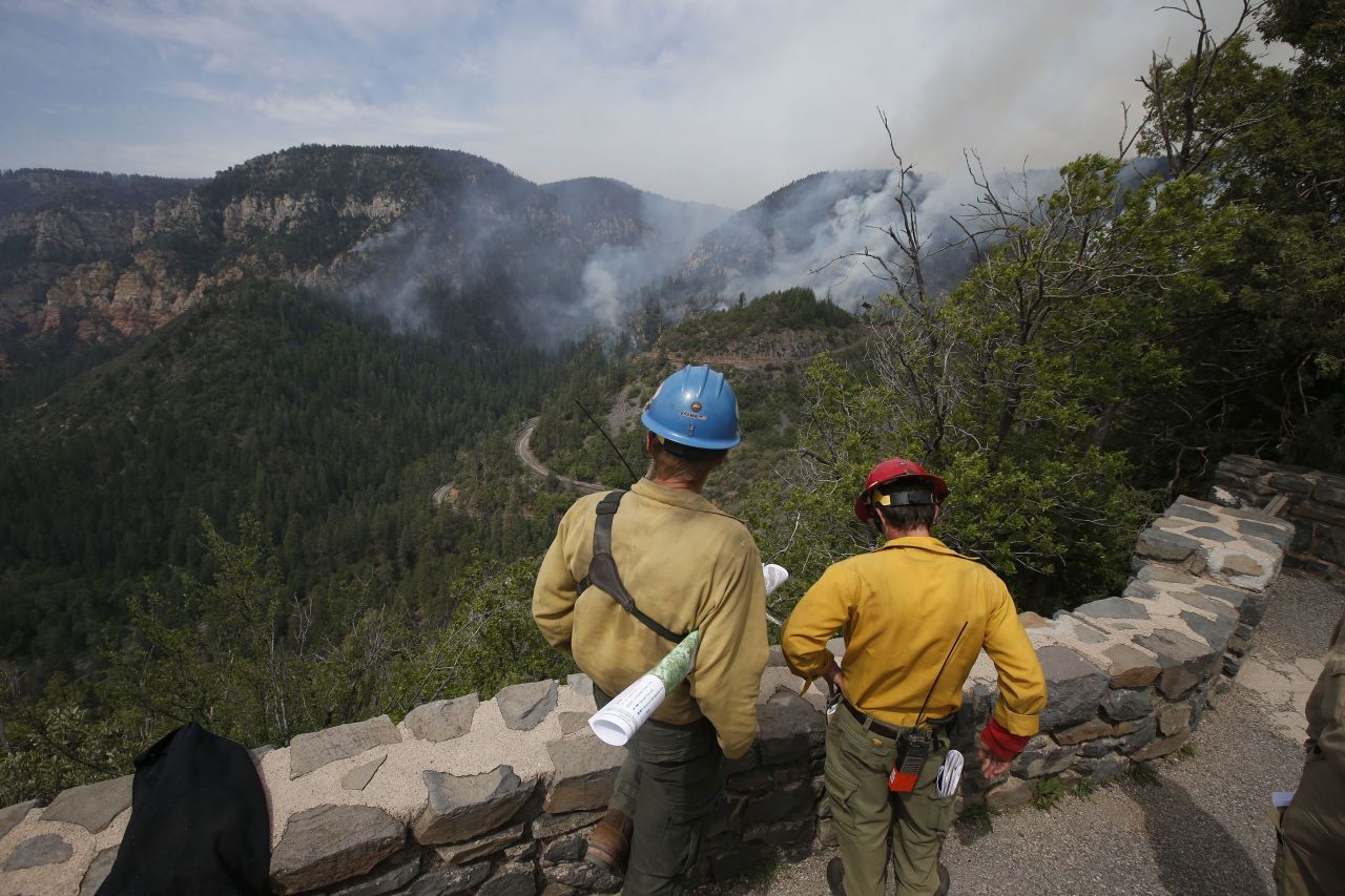 True Brown, left, of the Blue Ridge Hotshots, and Mark Adams of the Mormon Lake Hotshots take a high vantage point as spotters for those fighting a wildfire near Flagstaff, Arizona, on Friday, May 23. The fast-growing fire, dubbed the Slide Fire because it is just north of Slide Rock State Park, threatens several hundred homes and rental cabins in the area.