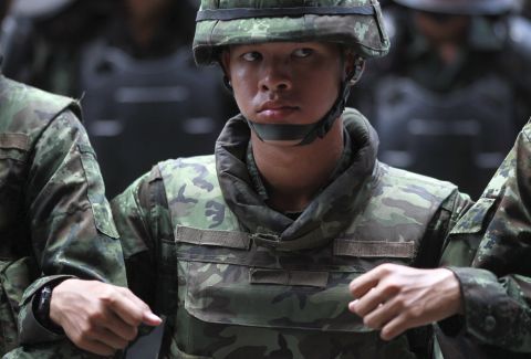 Thai soldiers link arms as they monitor a protest outside a Bangkok shopping complex on May 24.