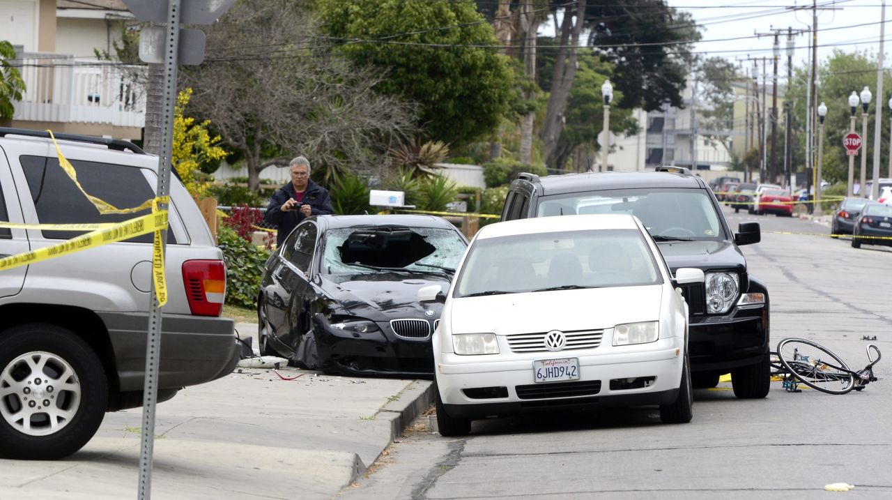 A police officer inspects the gunman's car on May 24 after the killing spree in Isla Vista. The suspect, described as mentally disturbed and possibly bent on retribution, sprayed bullets from his car in a rampage called "premeditated mass murder," Santa Barbara County sheriff's deputies said. 