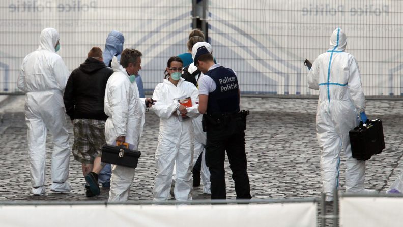 Police and crime scene investigators work at the scene of the shootings on May 24. A person arrived by car at the museum, entered and quickly opened fire before leaving, Belgian Interior Minister Joelle Milquet told CNN affiliate Bel RTL.