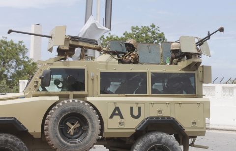 African Union troops arrive in an armored vehicle.