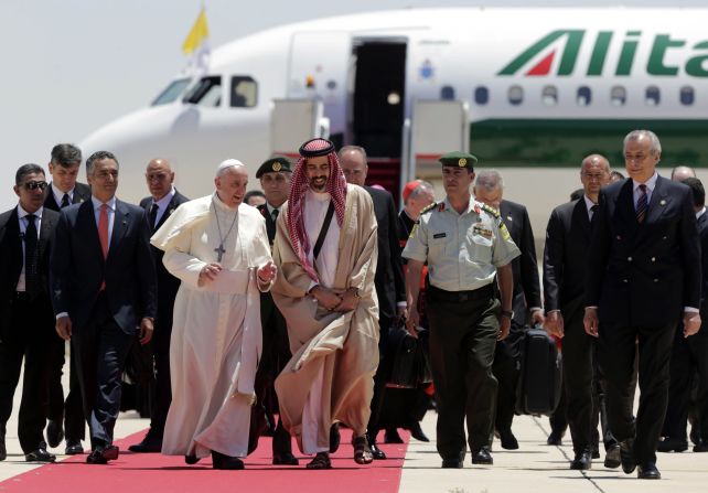 Pope Francis walks with Jordanian Prince Ghazi, chief adviser to the King of Jordan for Religious and Cultural Affairs, on May 24 as he arrives at the Amman airport.