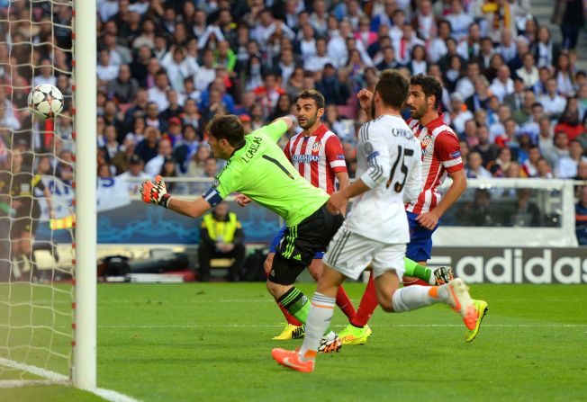 Casillas makes a desperate attempt to keep out Godin's header as his side fell behind in the Champions League final. 