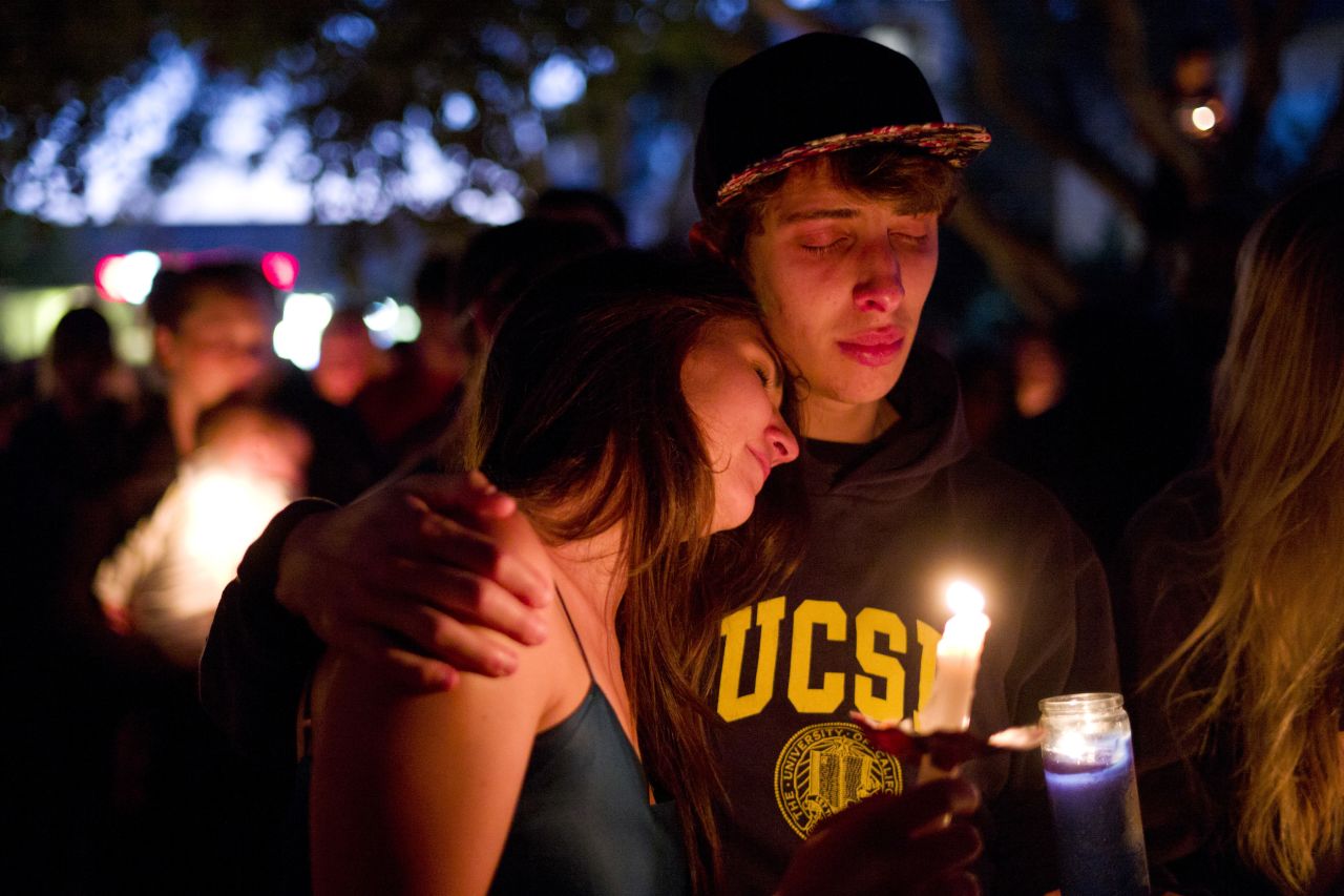 Two students comfort each other during the candlelight vigil to honor the victims of Friday night's mass shooting in Isla Vista. 
