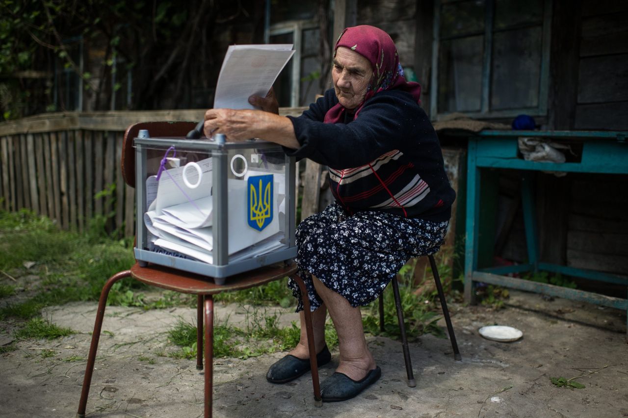 An elderly woman casts her vote May 25 as a mobile Ukrainian election committee visited Orane, a village north of Kiev.