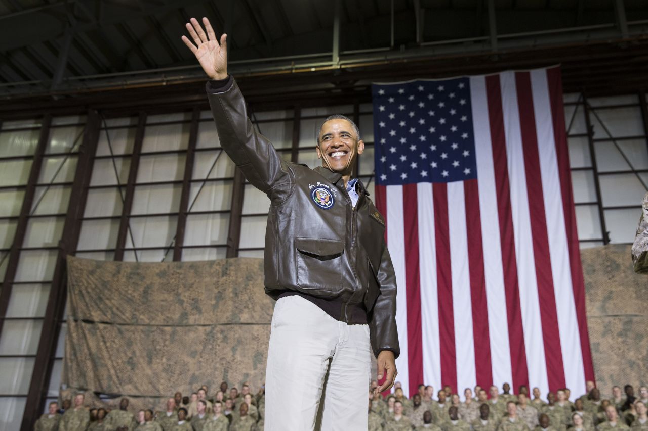 The President waves as he arrives for the troop rally.