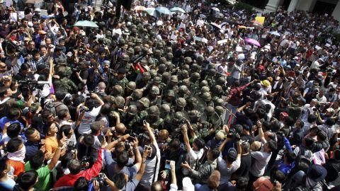 Thai soldiers are surrounded by anti-coup protesters on May 25 during a demonstration in Bangkok.