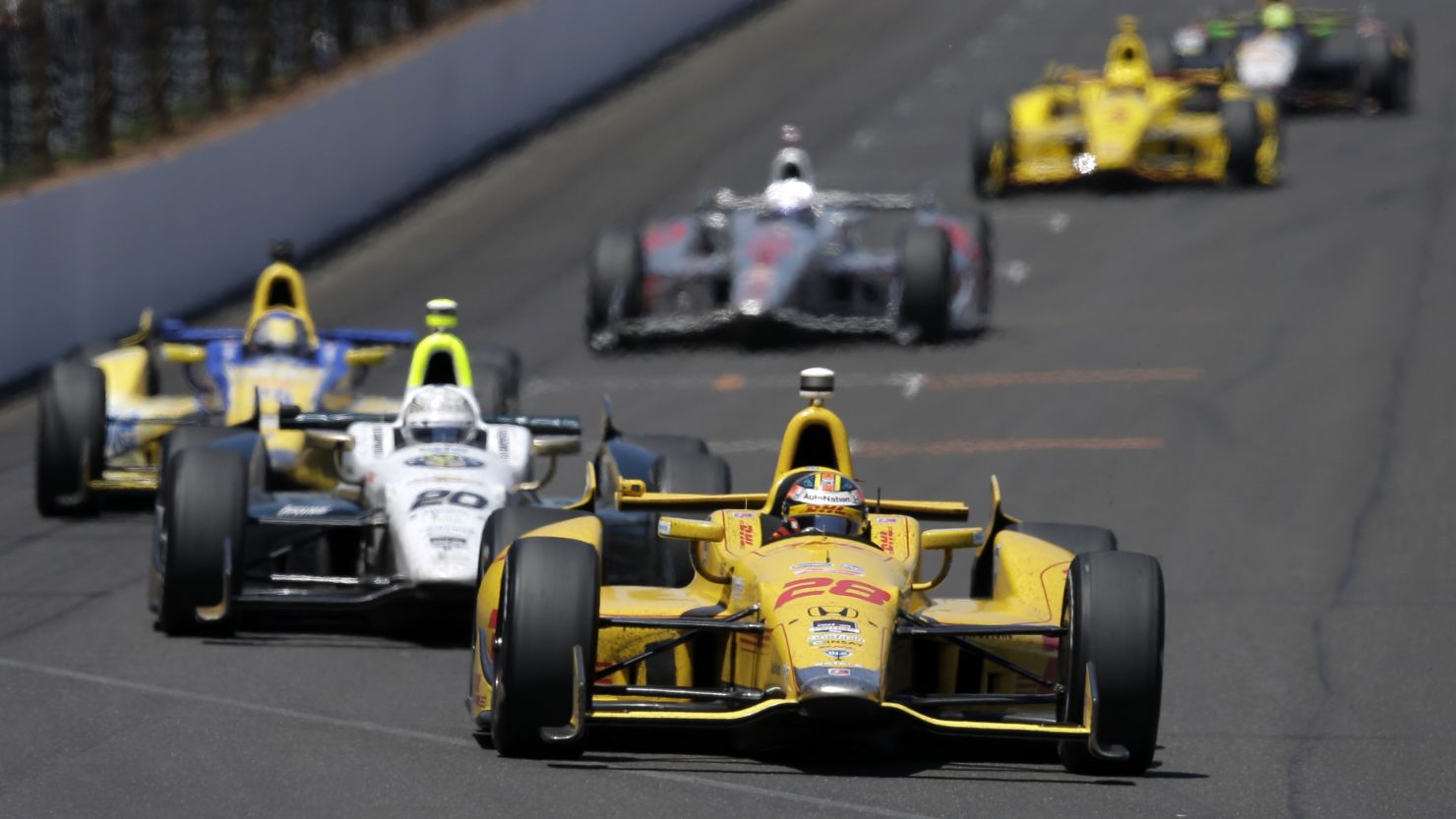 Ryan Hunter-Reay leads Ed Carpenter into the first turn during the 98th running of the Indianapolis 500 on Sunday, May 25.