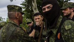 A Pro-Russian militant smokes a cigarette during a briefing at a check-point on the road between Donetsk and Mariupol, eastern Ukraine, on May 25, 2014.