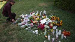  A man places flowers on the lawn of the Alpha Phi sorority house May 25, 2014 in Isla Vista, California.
