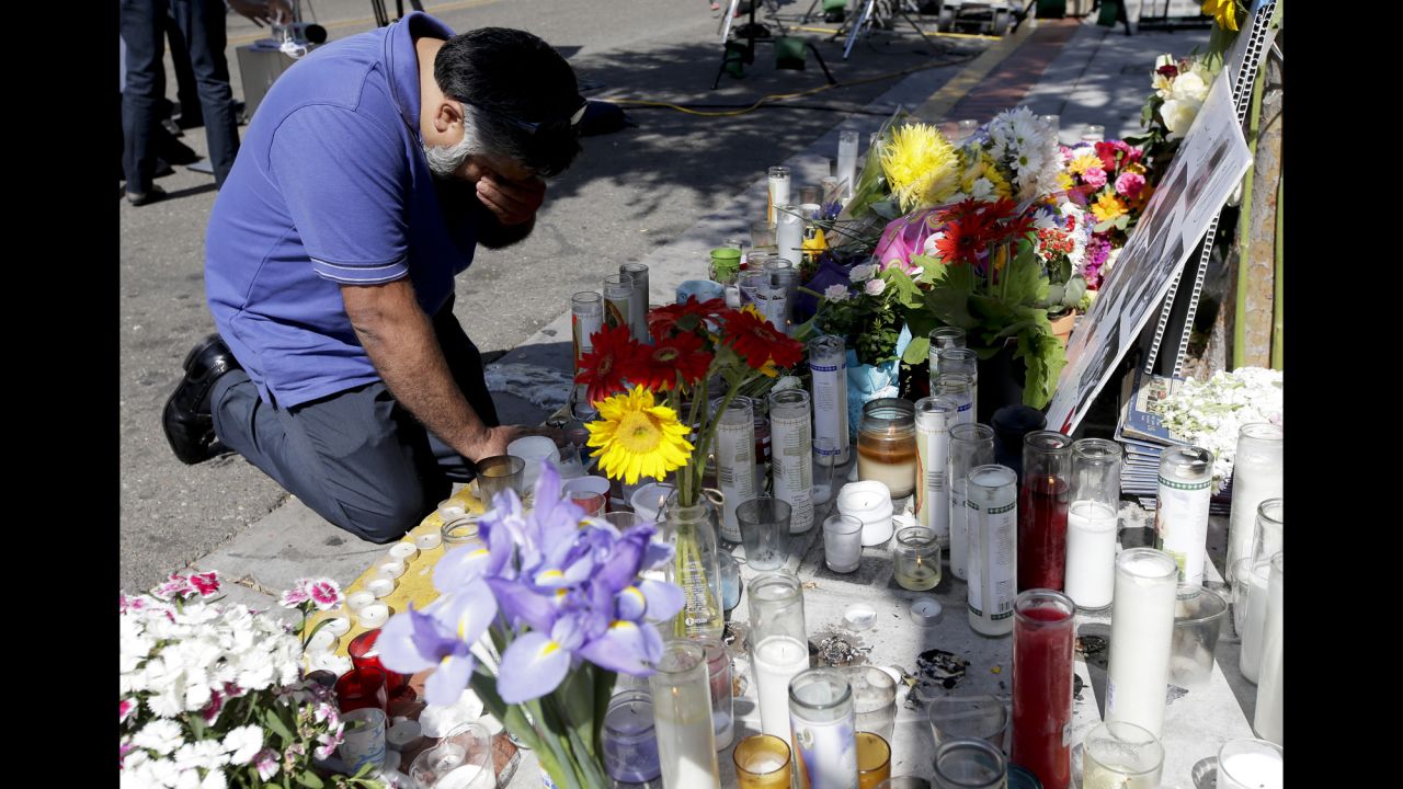 Jose Cardoso pays his respects Sunday, May 25, at a makeshift memorial at the IV Deli Mart, where part of a mass shooting took place, in Isla Vista, California. Elliot Rodger, 22, went on a rampage Friday night, May 23, near the University of California, Santa Barbara, stabbing three people to death at his apartment before shooting and killing three more in a nearby neighborhood, sheriff's officials said. Rodger also injured 13 others and died of an apparent self-inflicted gunshot wound, authorities said.<br />