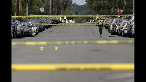A Santa Barbara County deputy sheriff walks along the street May 24 near a shooting scene in Isla Vista.
