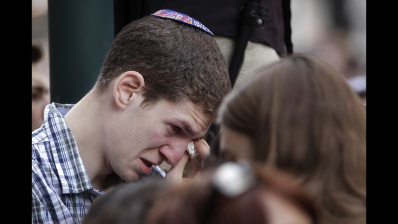 A man wipes away tears during a vigil in front of the museum on May 25.