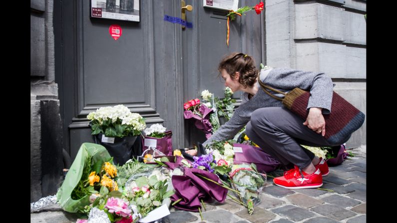 A woman lays flowers at the museum entrance on May 25.