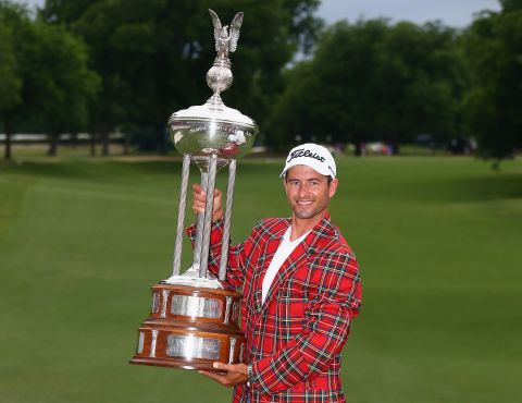 Adam Scott gets to grip with the massive Leonard Trophy after claiming the Colonial tournament in Texas.