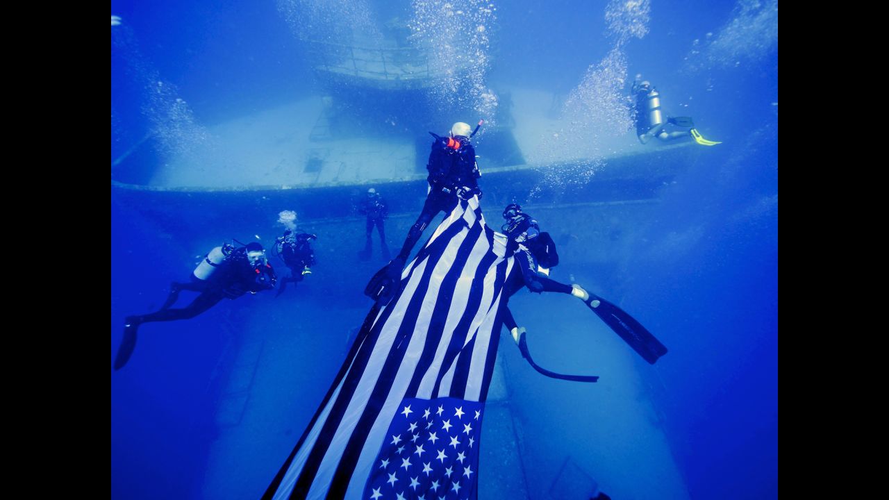 Divers deploy an American flag on the USNS General Hoyt S. Vandenberg, an artificial reef about seven miles off Key West, Florida, on May 25, 2014.