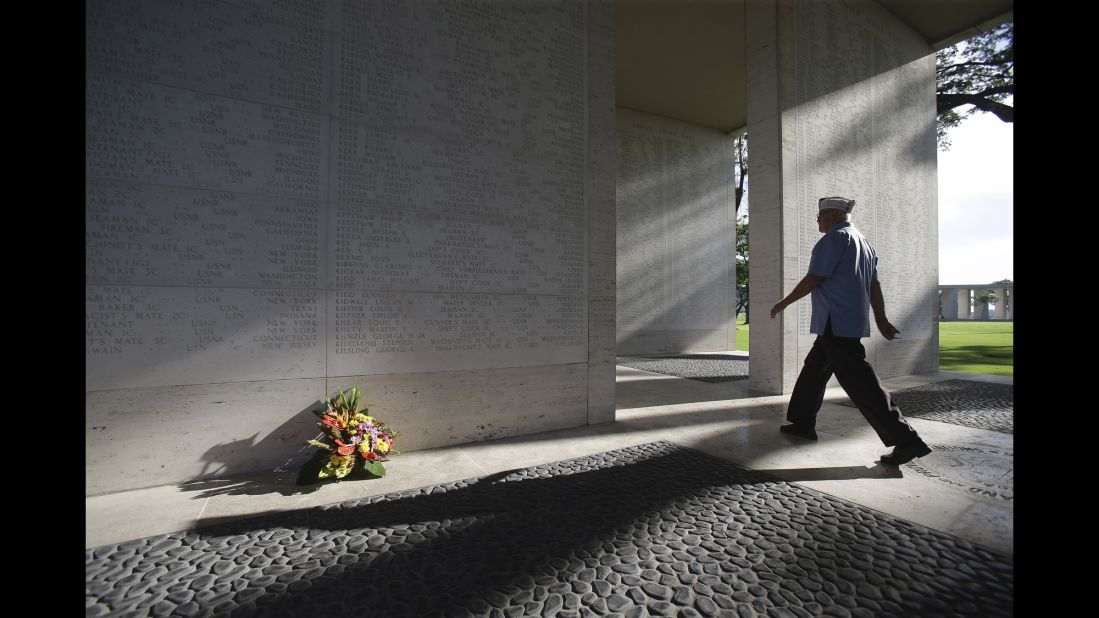 An American veteran passes by marble walls engraved with names of fallen U.S. soldiers at the Manila American Cemetery and Memorial in Taguig, Philippines, on May 25, 2014.