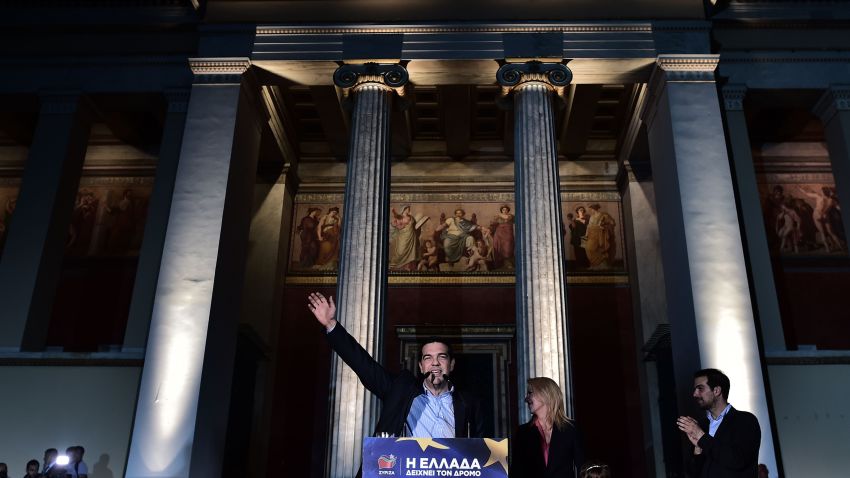 Syriza's leader Alexis Tsipras, candidate to head the European Commission for the European Left, waves at his supporters after the results of the European elections, outside the Athens University, on May 25, 2014. Greece's anti-austerity leftist party Syriza held a slight lead in European Parliament elections, exit polls showed on Sunday. Syriza's 39-year-old leader Alexis Tsipras said the government had lost its legitimacy and called for national elections..