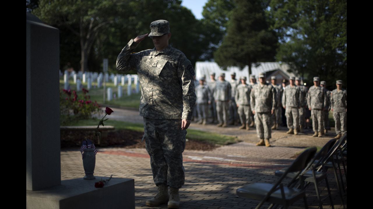 Pvt. John Schena of the Georgia State Defense Force salutes after placing a rose at a Pearl Harbor memorial May 26, 2014, at Marietta National Cemetery in Marietta, Georgia.