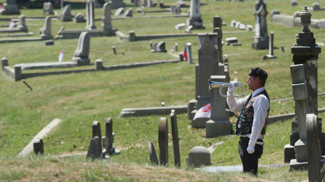 Robert Becker performs taps during a ceremony May 26, 2014, at Blandford Cemetery in Petersburg, Virginia.