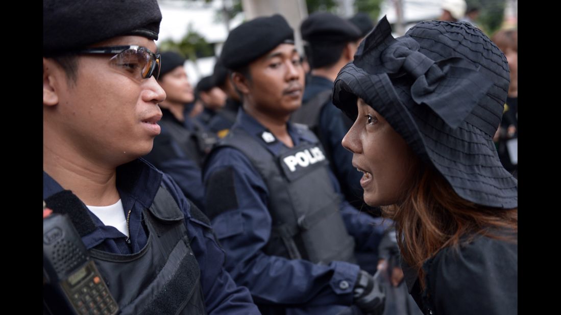 An anti-coup protester faces riot police during a May 26 rally in Bangkok.