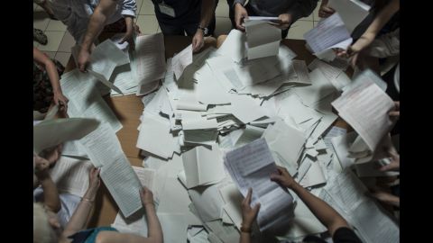 Election commission officials count ballots at a polling station in Kiev on Sunday, May 25.